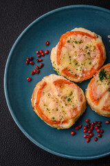 Delicious baked fish fillet with cheese, tomatoes, salt, spices and herbs