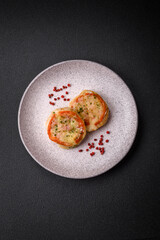 Delicious baked fish fillet with cheese, tomatoes, salt, spices and herbs