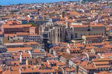 Fototapeta na wymiar Aerial view from the Castle of Saint George with panoramic views of the Church of the Convento do Carmo and the Elevador de Santa Justa elevator, with the roofs of the city of Lisbon, Portugal