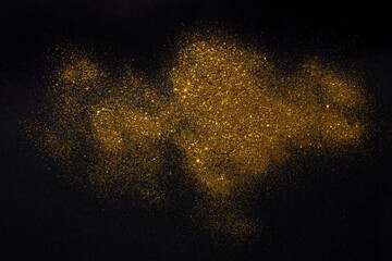 group of Golden flakes are scattered on the black surface. gold particle for graphic resources.