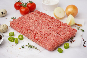 Fresh minced meat with spices on white background