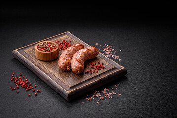 Delicious grilled chicken or pork sausages with salt and spices - obrazy, fototapety, plakaty