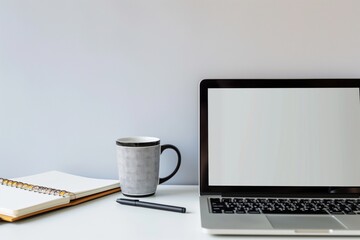 empty frame with laptop, coffee mug, and notebook on white desk