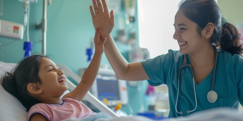 woman nurse or medical staff give a high five to little girl patient - obrazy, fototapety, plakaty