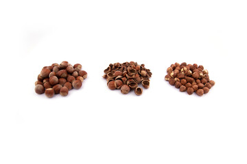heap of in-shell hazelnuts, heap of hazelnut kernels, heap of hazelnut shells. hazelnuts on a white background