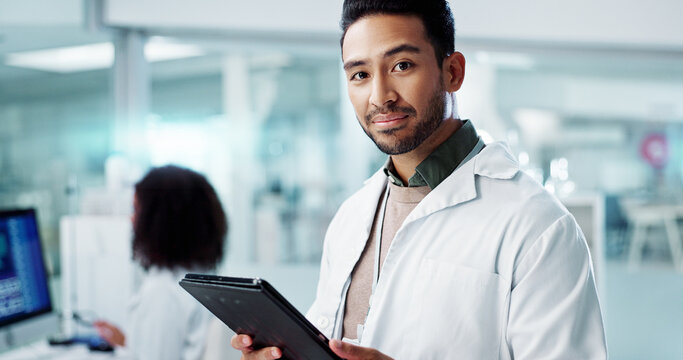 Man, face and scientist with tablet in laboratory and online research of genetics specialist in healthcare. Asian doctor, portrait and happy at work in pharmaceutical career and working on innovation