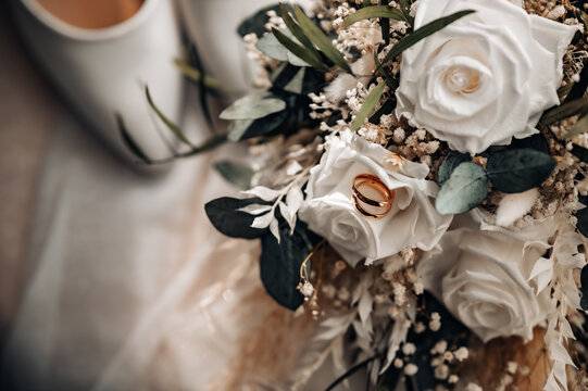 Beautiful rustic boho wedding bouquet and rings close up.
