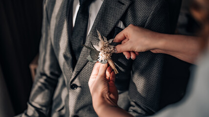 Close-up of the the bride holding buttonhole