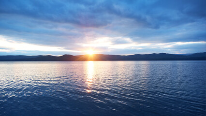 Lake sunset over the mountains