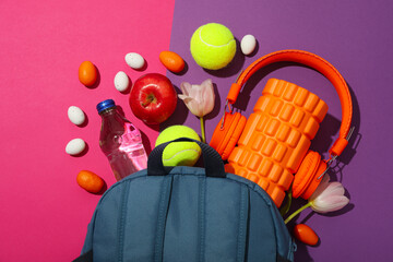 Sports accessories with spring flowers, on a purple background.