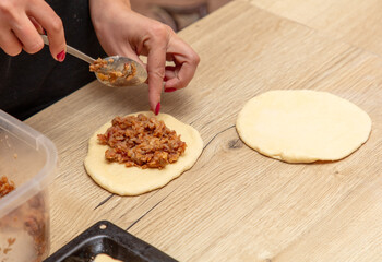 Woman preparing buns with jam from doug