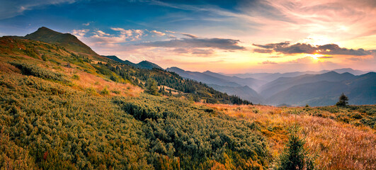 Fantastic sunset in Carpathian mountains with Pip Ivan summit on background. Panoramic summer view...