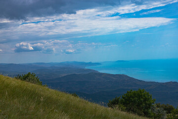 View from the top of Mount Demerdzhi to the mountainous green valley and the sea. Landscape