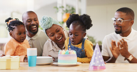 Birthday, children party and applause with a family in celebration of a girl child in their home. African parents, grandparents and kids clapping while blowing candles on a cake at a milestone event - Powered by Adobe
