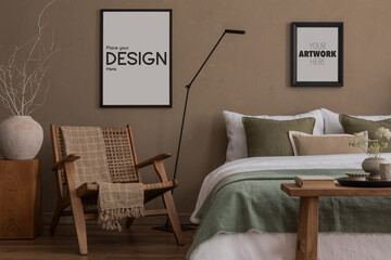Cozy bedroom interior with mock up poster frame, bed, white and green bedding, rattan armchair, black lamp, wooden bench, plaid, vase with branch and personal accessories. Home decor. Template.