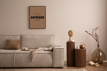 Interior design of elegant composition with mock up poster frame, modern beige sofa, brown pillow, elegant wooden stand, patterned carpet, books and accessories. Home decor. 