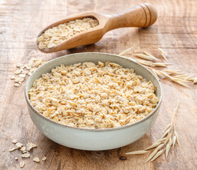 Bowl of porridge or oatmeal on wooden table.