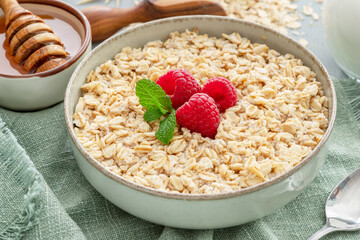 Bowl of porridge or oatmeal with fruits close up. Breakfast concept.