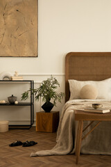 Warm bedroom interior with mock up poster frame, cozy bed, beige bedding round pillow, black rack,...