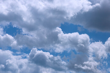 Heavenly cloudy landscape, white and gray clouds against the blue sky. Background.
