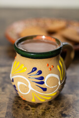 Traditional Mexican cup with hot chocolate drink. champurrado