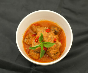 Cakalang Rica - Special Food from Manado Indonesia, made from Skipjack Fish Cooked in Spicy Aromatic Sambal. Served on white plate. Top view.
