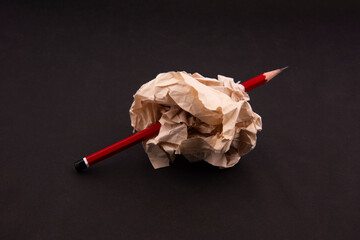 red pencil in crumpled paper. motivation, innovation, idea and success concept