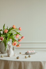 Minimalist composition of easter dining room interior with copy space, vase with tulips, colorful...