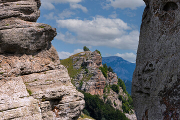 Mountain landscape, stone pillars in the form of ghosts in a mountain valley, a canyon against the sky.