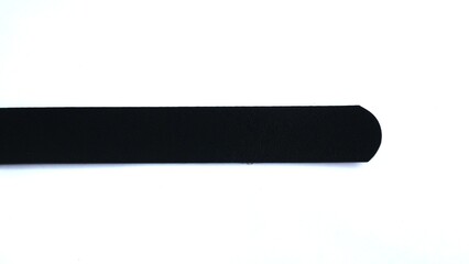 The synthetic leather belt is protected on a white background