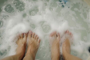 closeup on two sets of feet facing each other in a bubbly hot tub