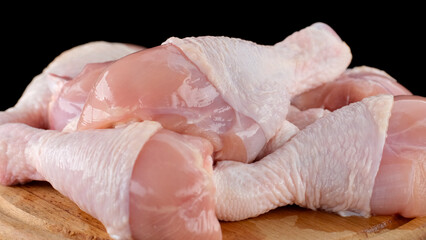 Fresh raw chicken legs isolated on black background