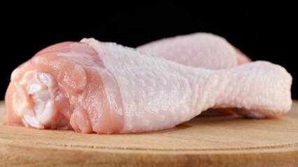 Fresh raw chicken legs isolated on black background