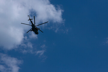 Military Russian helicopter flies in the sky. Bottom view.