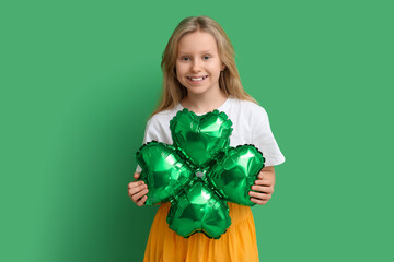 Cute little girl with air balloon in shape of clover on green background. St. Patrick's Day celebration