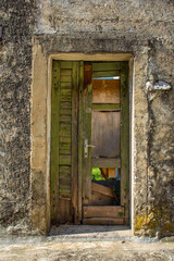 Fototapeta na wymiar An old wooden door in an abandoned house in the Stari Grad historic centre of the coastal town of Novi Vinodolski, Primorje-Gorski Kotar County, Croatia
