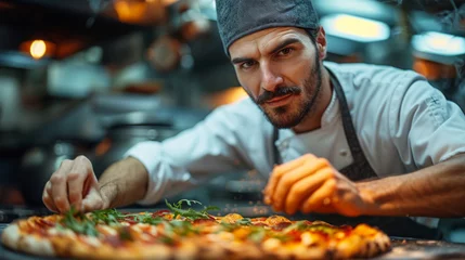 Tuinposter Pizza chef finishing the preparation of a tasty pizza in professional pizzeria restaurant kitchen © Keitma