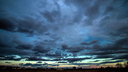 Stormy sky with dramatic clouds from an approaching thunderstorm at sunset. Stormy sky over the...