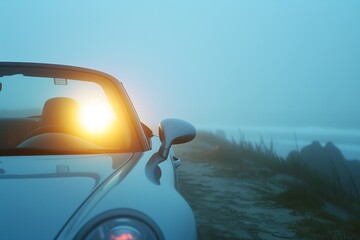 bright headlights from convertible car on foggy beachfront road - obrazy, fototapety, plakaty