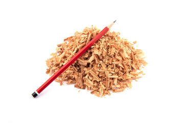 red wooden pencil on sawdust. sawdust pile and red pencil on white background