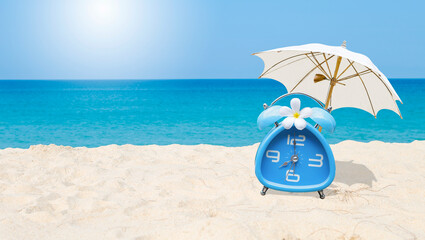Classic style blue alarm clock with plumeria flower and white beach umbrella with space on blurred tropical beach background, summer outdoor day light, holiday and vacation time
