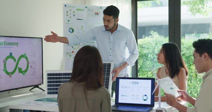 Group diverse Asia businesspeople talk ESG strategies risk management workshop, SDGs report, global warming, green finance and investment and net zero waste lifestyles in boardroom training building.