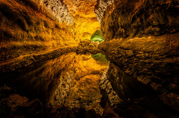 Discover the underground marvel of Cueva de los Verdes in Lanzarote, a stunning reflection in the volcanic tunnel waters, perfect for captivating imagery.