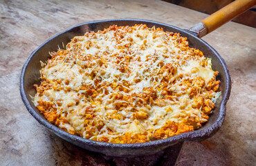 dish with cheese in a cast iron frying pan