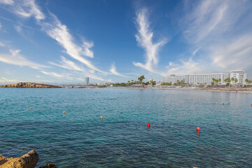 Vacation resort of Ayia Napa. A paradise for vacationers. A sunny day with a blue sky and white clouds. Panoramic view of the hotels and Nissi beach.
