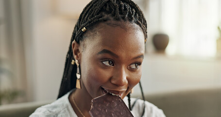 Home, eating and black woman on sofa, chocolate bar and dessert with happiness, relax and sugar...