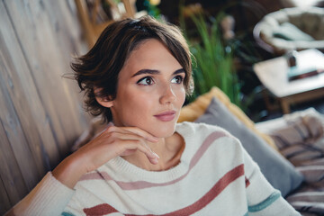 Photo of creative peaceful person sitting couch hand touch face look away brainstorming fantasize...