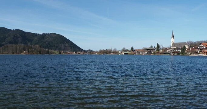 Landscapes of the Bavarian Alps. The town of Schliersee and Saint Sixtus Church along the northern shore of the lake in front of Freudenberg at the end of the western shore
