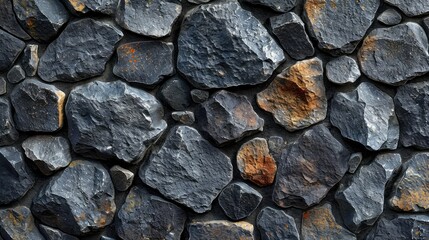 Textured background of a stone wall with various shapes and shades of grey and brown stones tightly fitted together.
