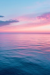 Soft, pastel hues reflecting off a tranquil seascape during twilight.
